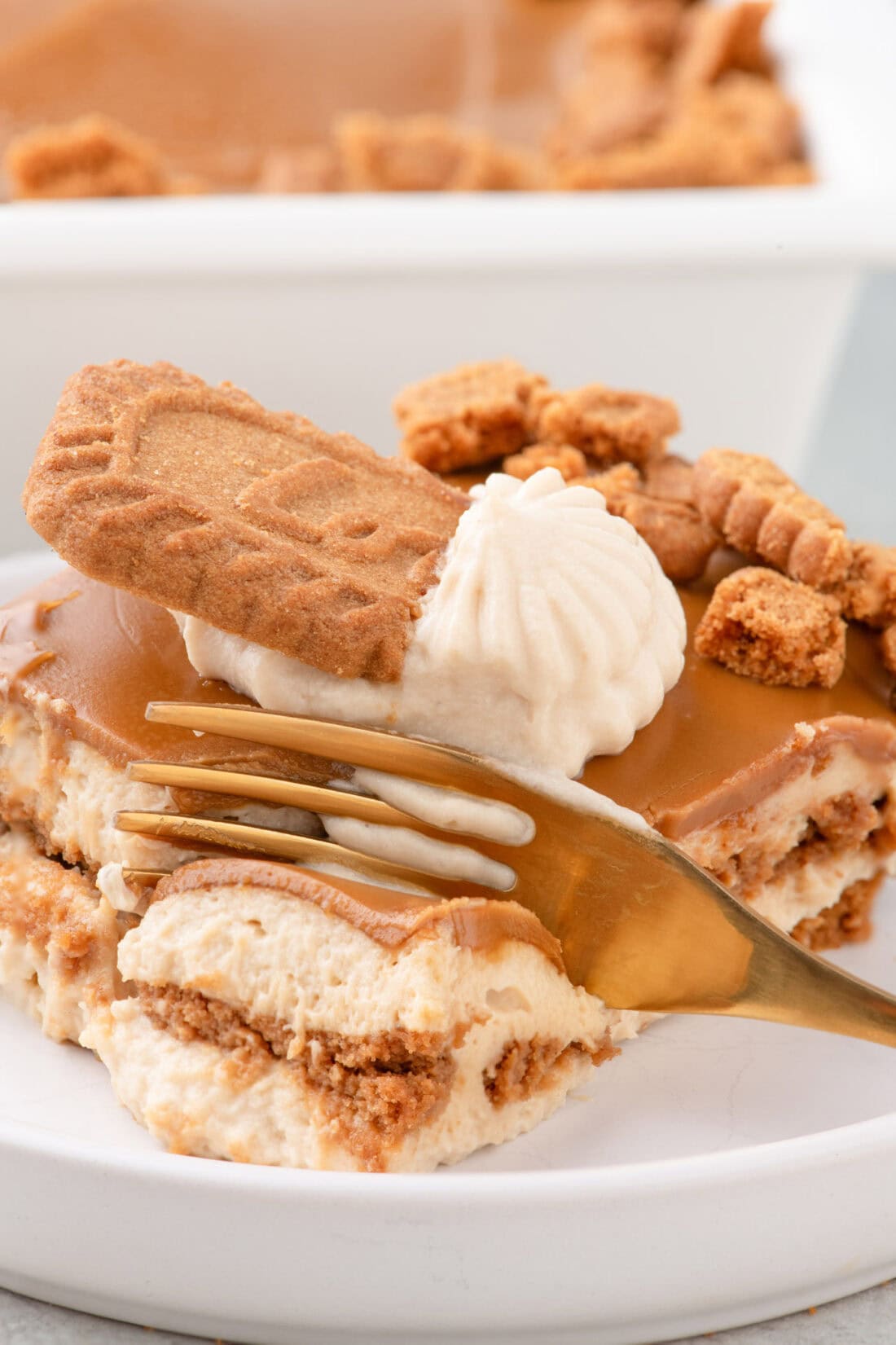 Fork breaking apart a piece of Biscoff Icebox Cake