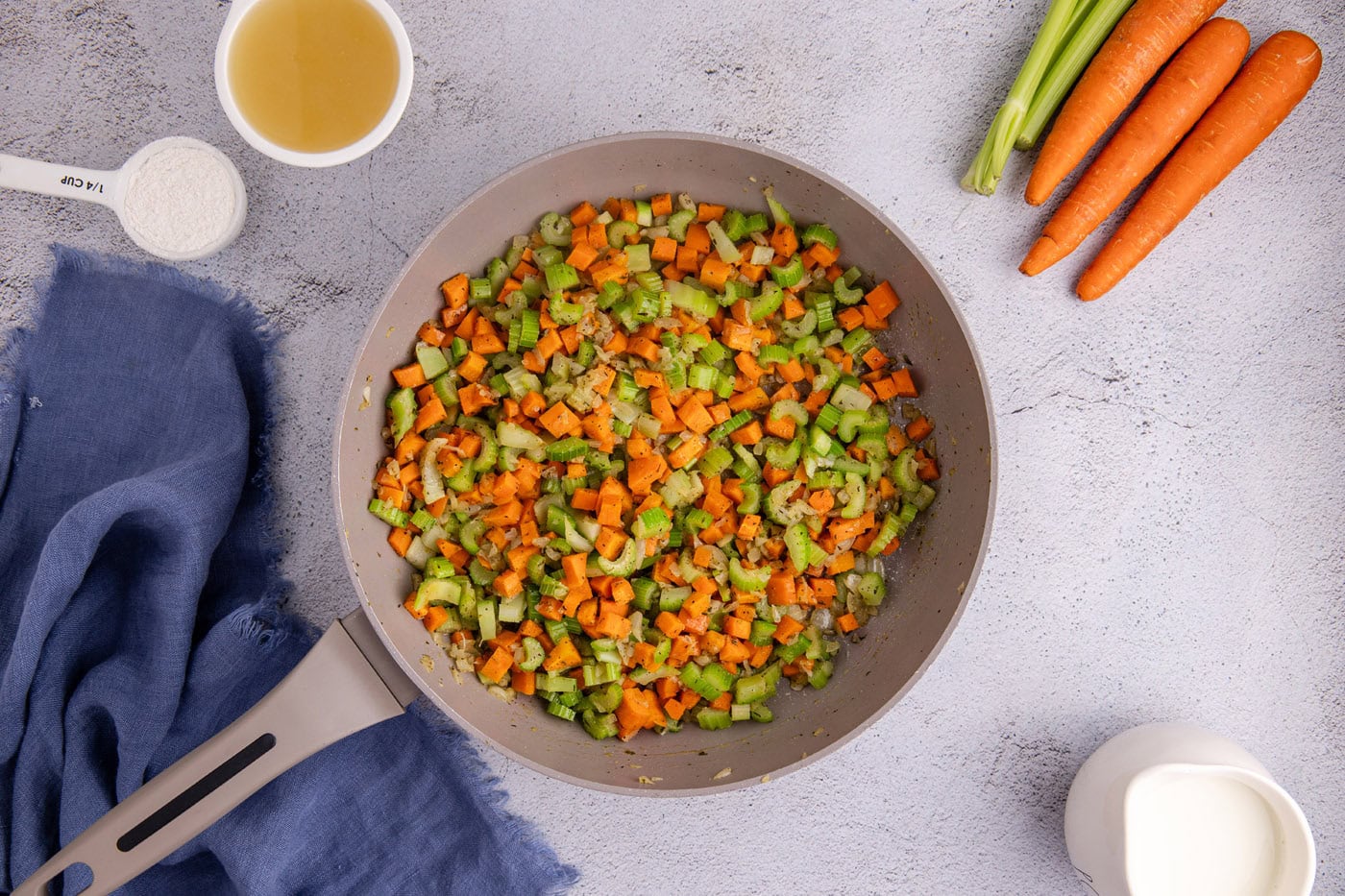 sauteed carrots, onion, and celery in a skillet with butter