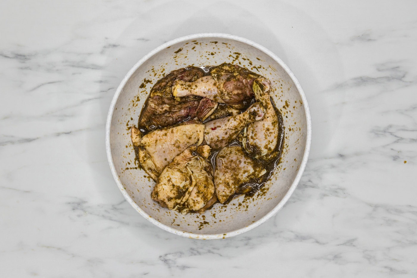 chicken in a large bowl coated in marinade