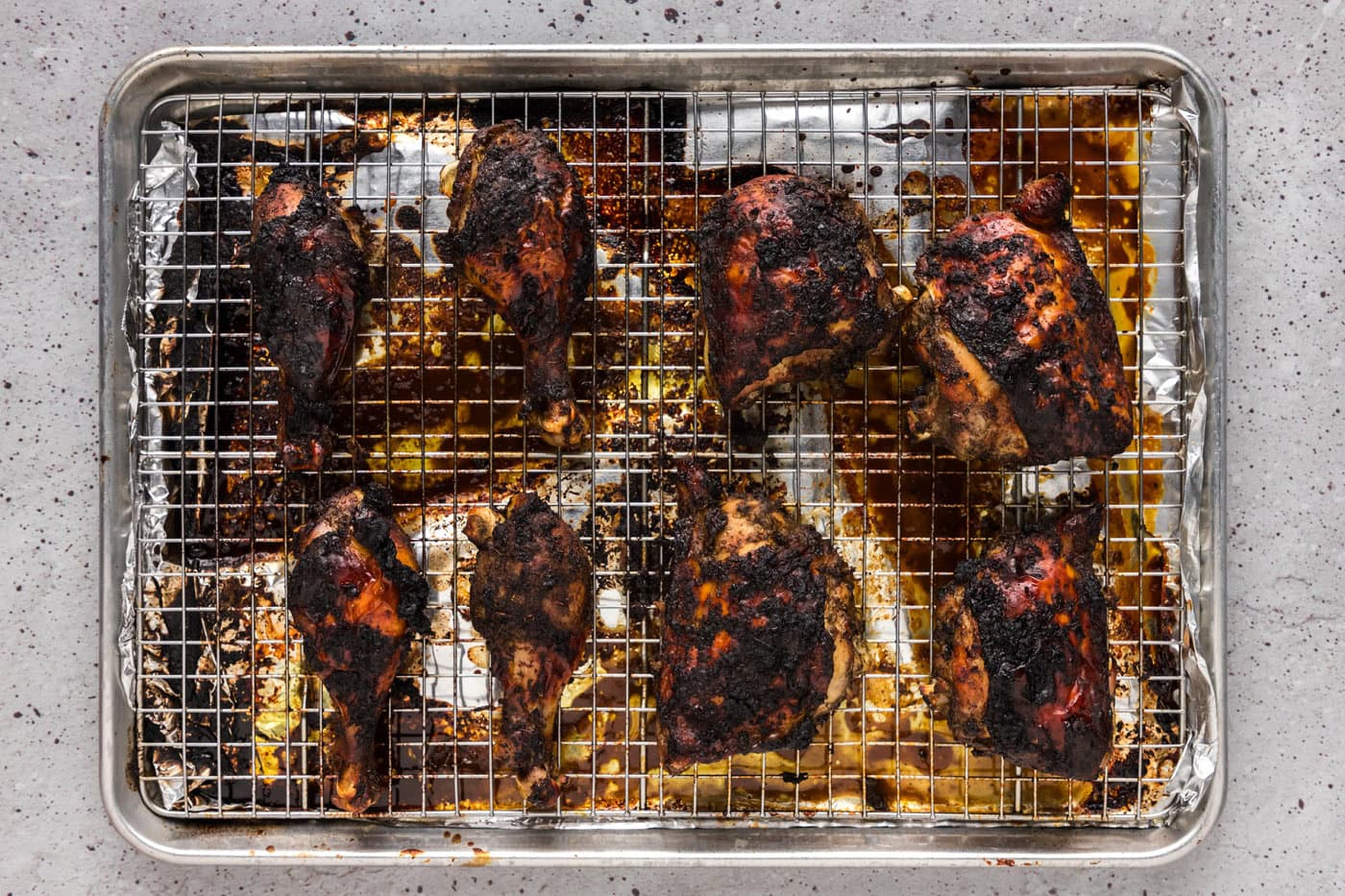 baked jerk chicken on a baking sheet