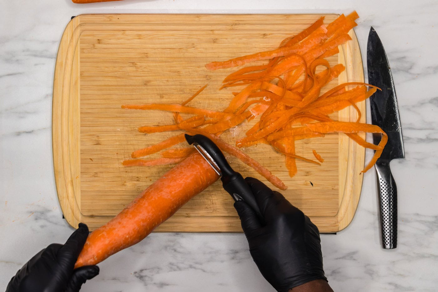 peeling carrot with a vegetable peeler