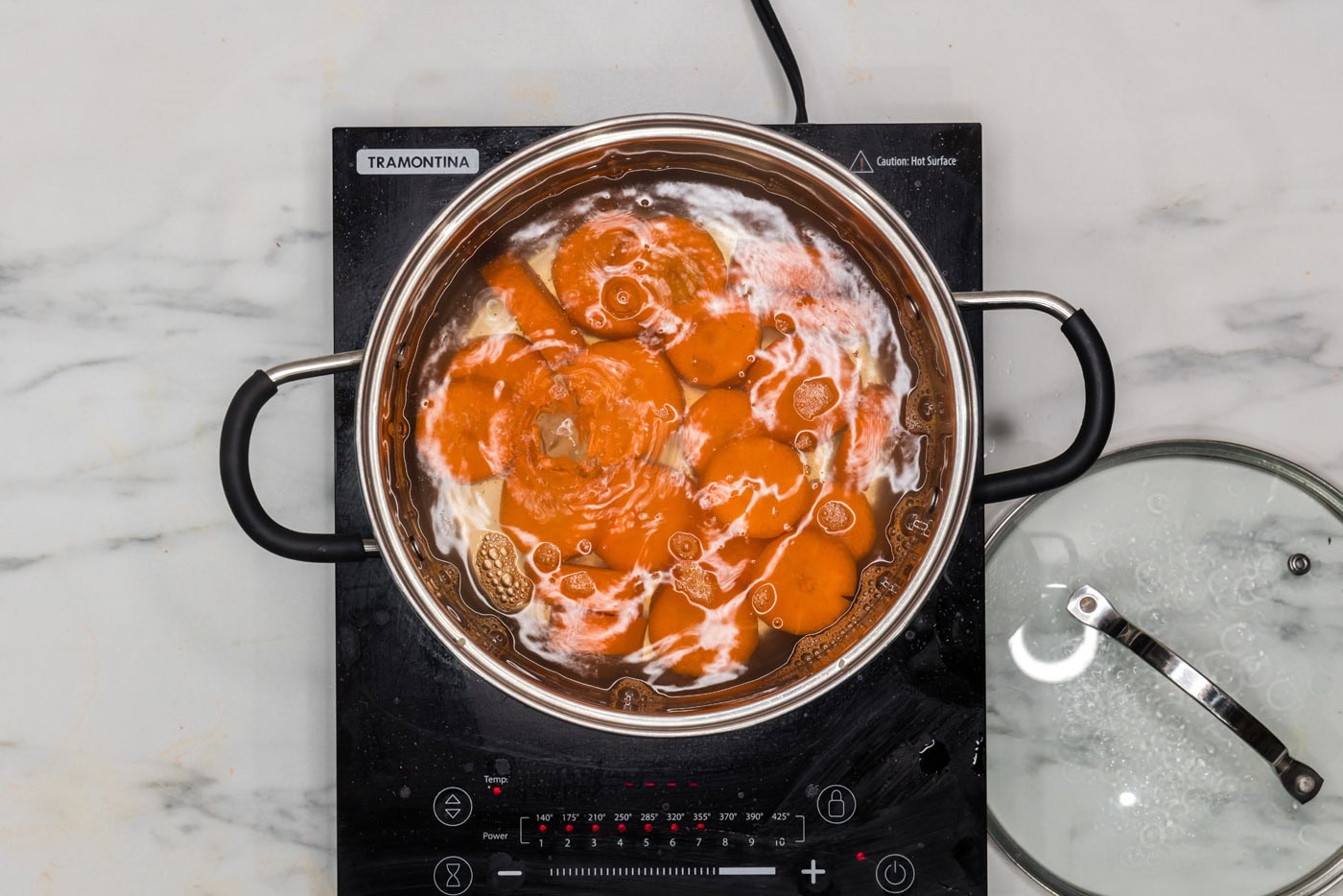 boiling carrots in a pot of water