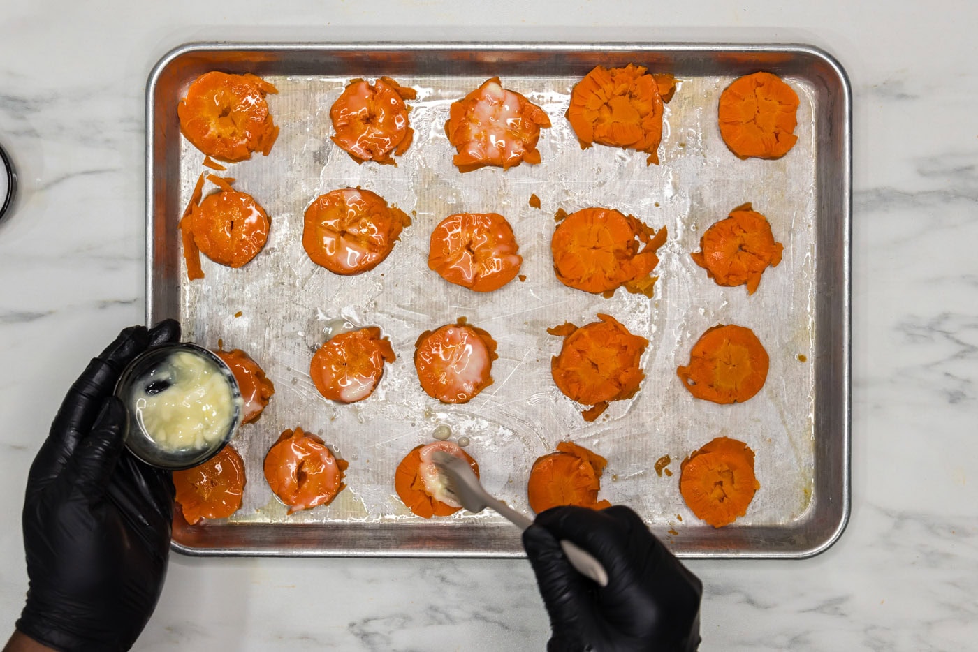 brushing smashed carrots with butter