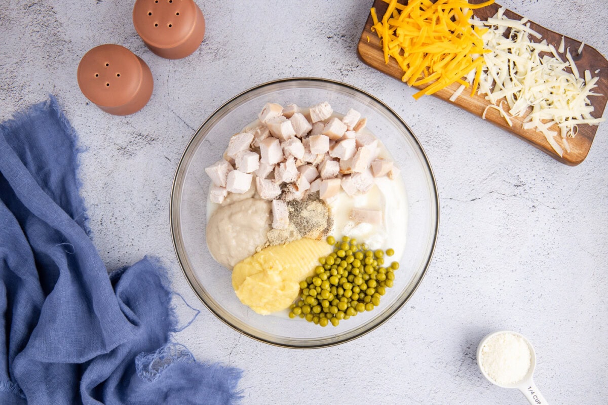 cubed turkey, sour cream, peas, cream of chicken and mushroom soup and seasonings in a bowl