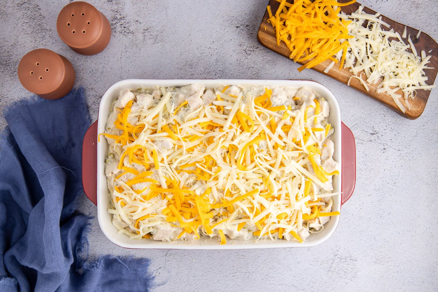 shredded cheese on top of turkey tetrazzini casserole