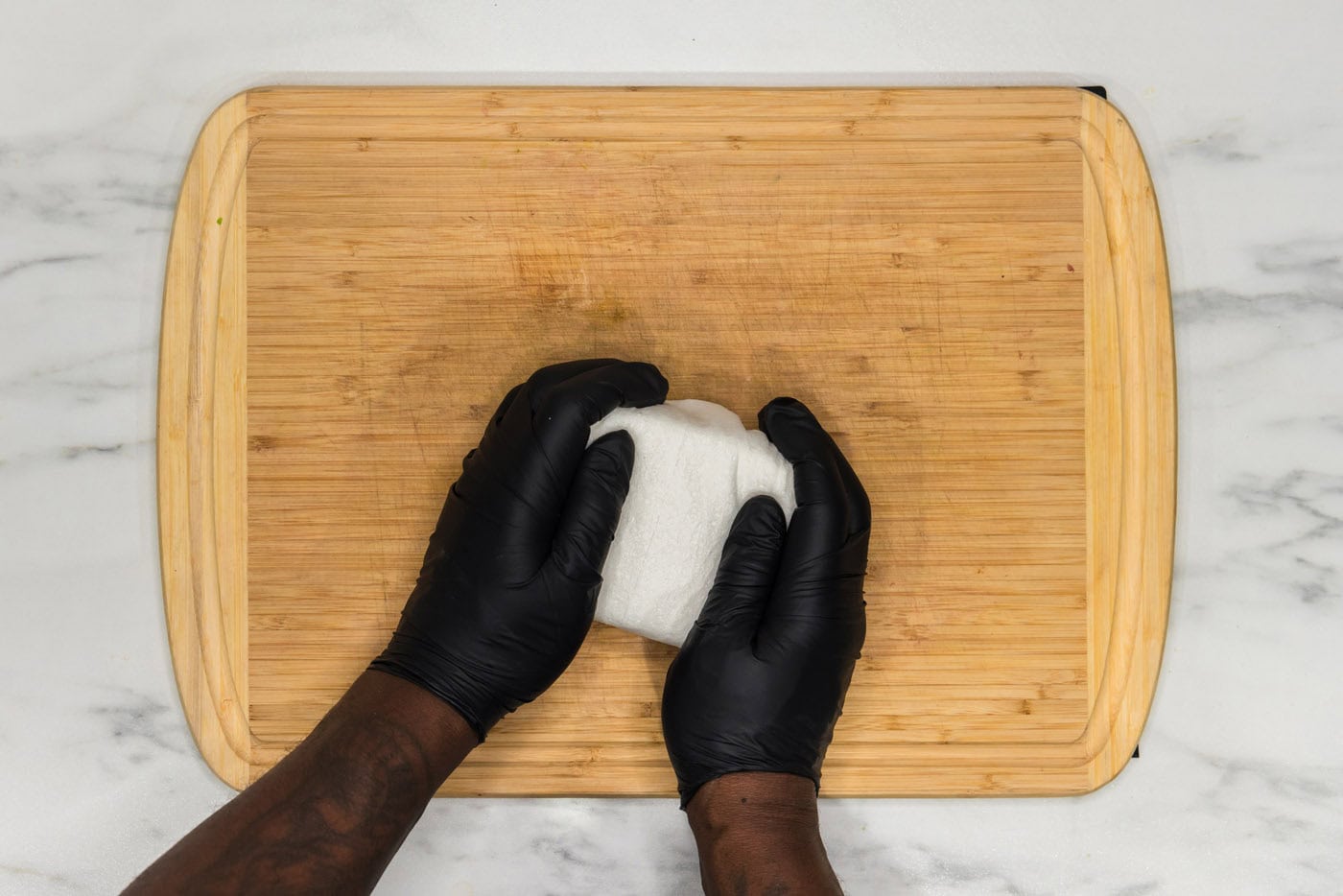 squeezing excess moisture out of tofu block