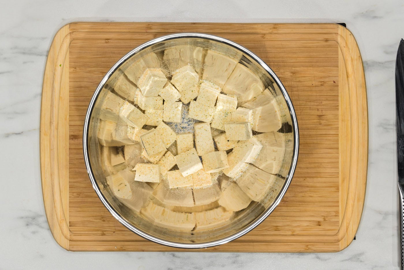 cubed tofu in a bowl with seasonings