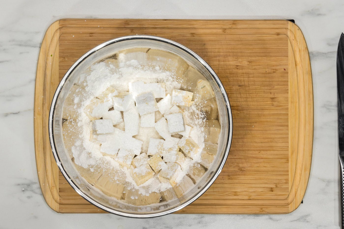 cornstarch added to bowl of tofu