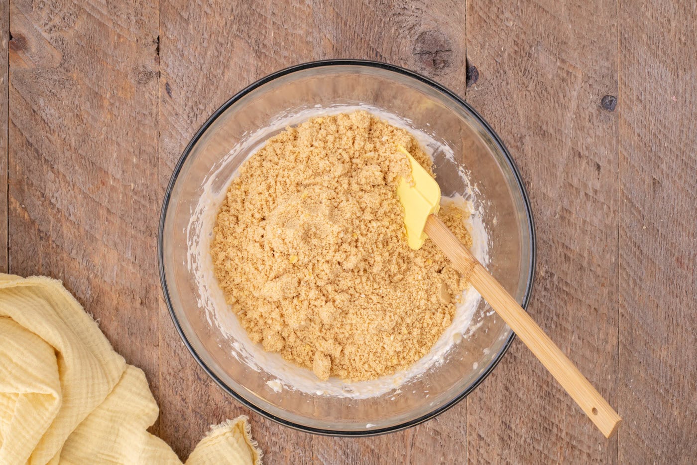 combining crushed oreo mixture with banana and cream cheese mixture with a rubber spatula