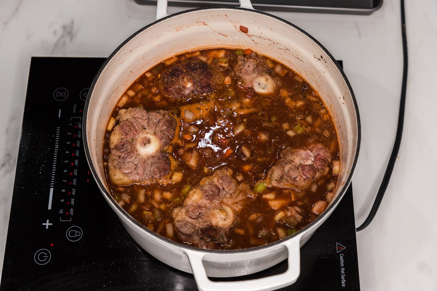 oxtail braised in a dutch oven with red wine sauce