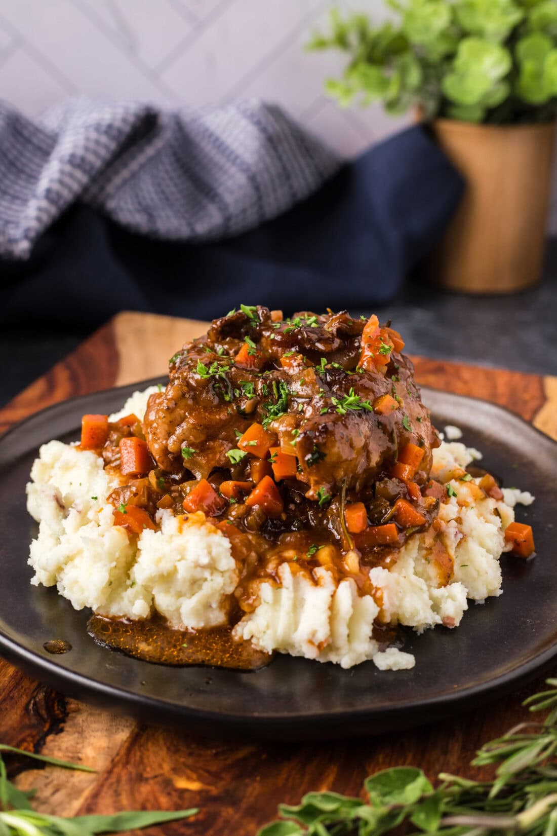 Braised Oxtail served over mashed potatoes on a plate