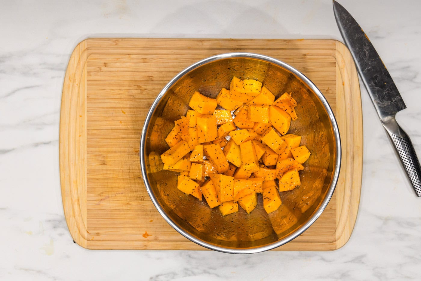 cubed butternut squash in a mixing bowl