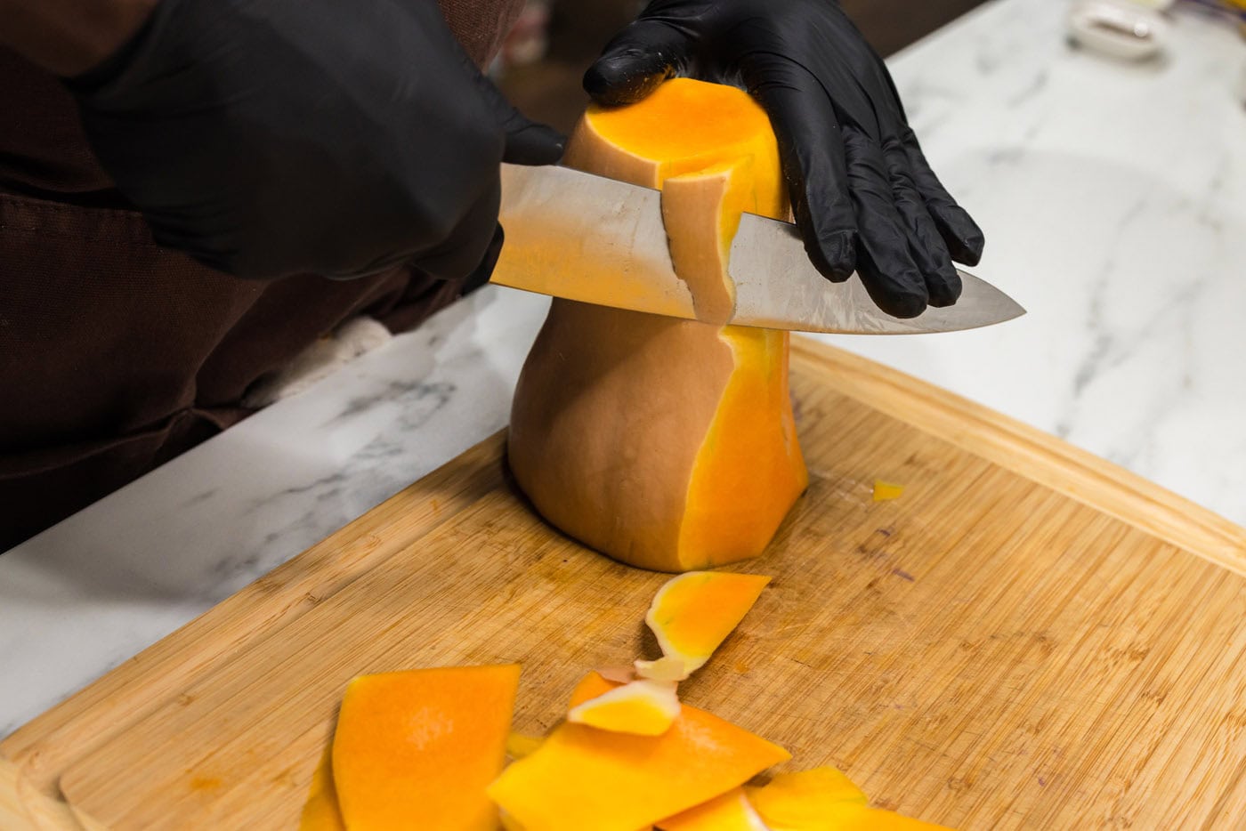 peeling skin off of butternut squash with a knife