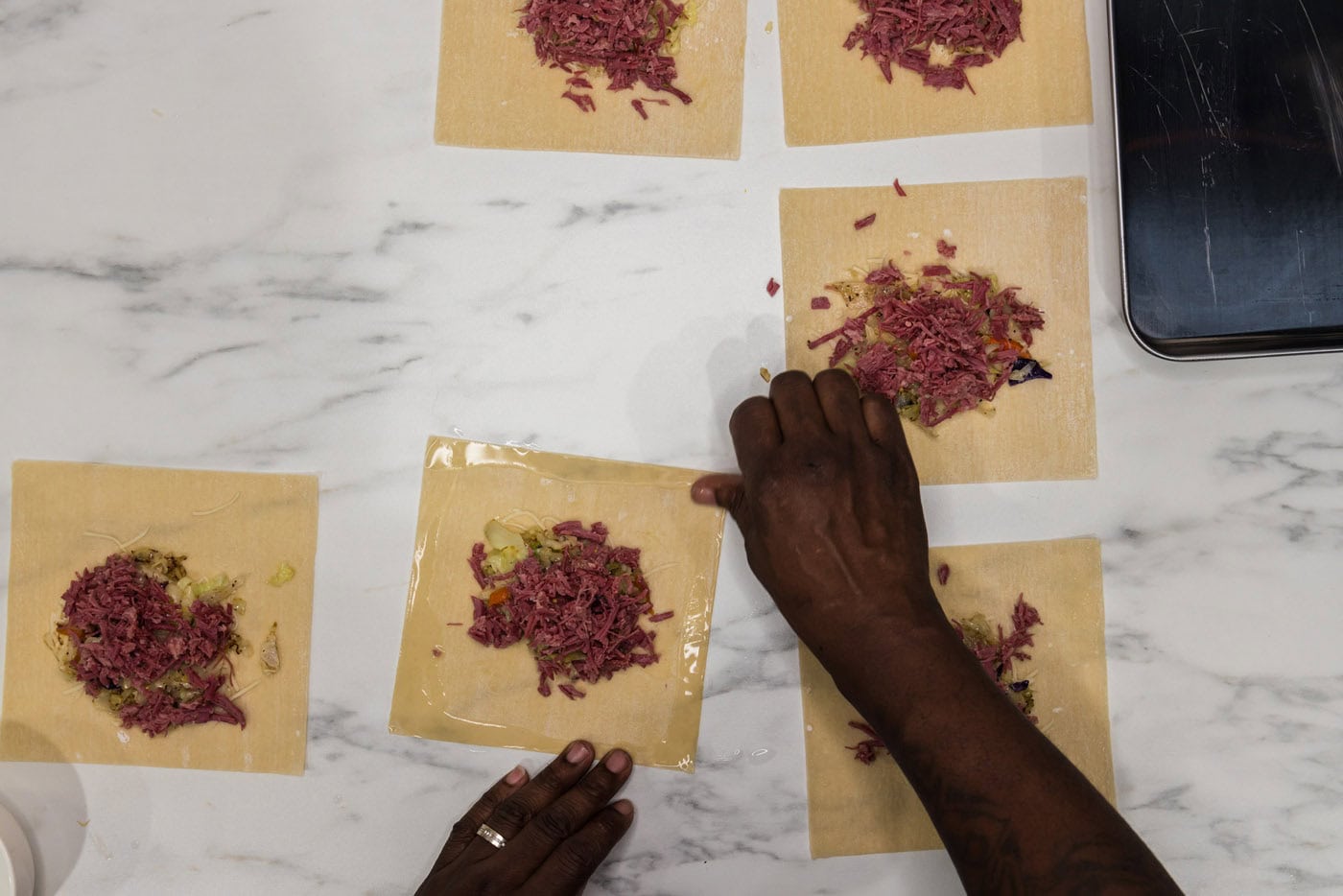 wetting the edges of egg roll wrappers with water