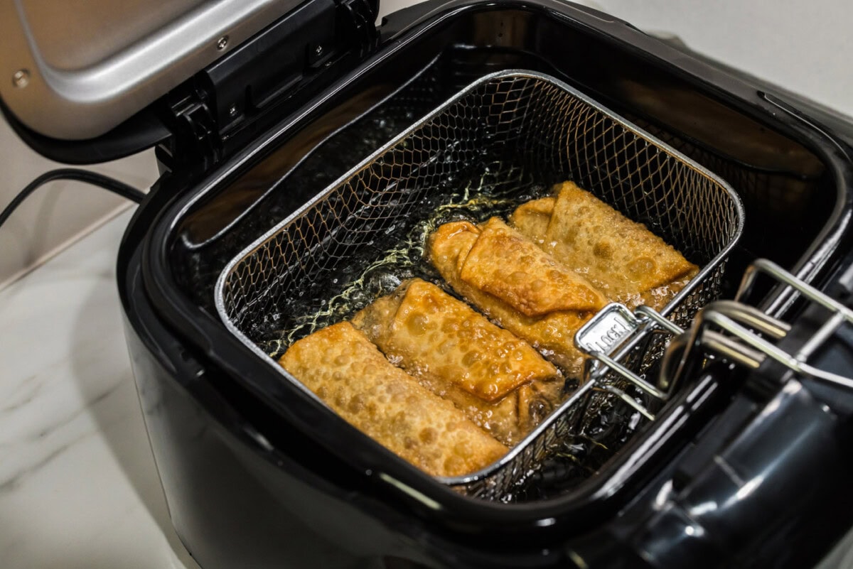 deep fried egg rolls in fryer basket