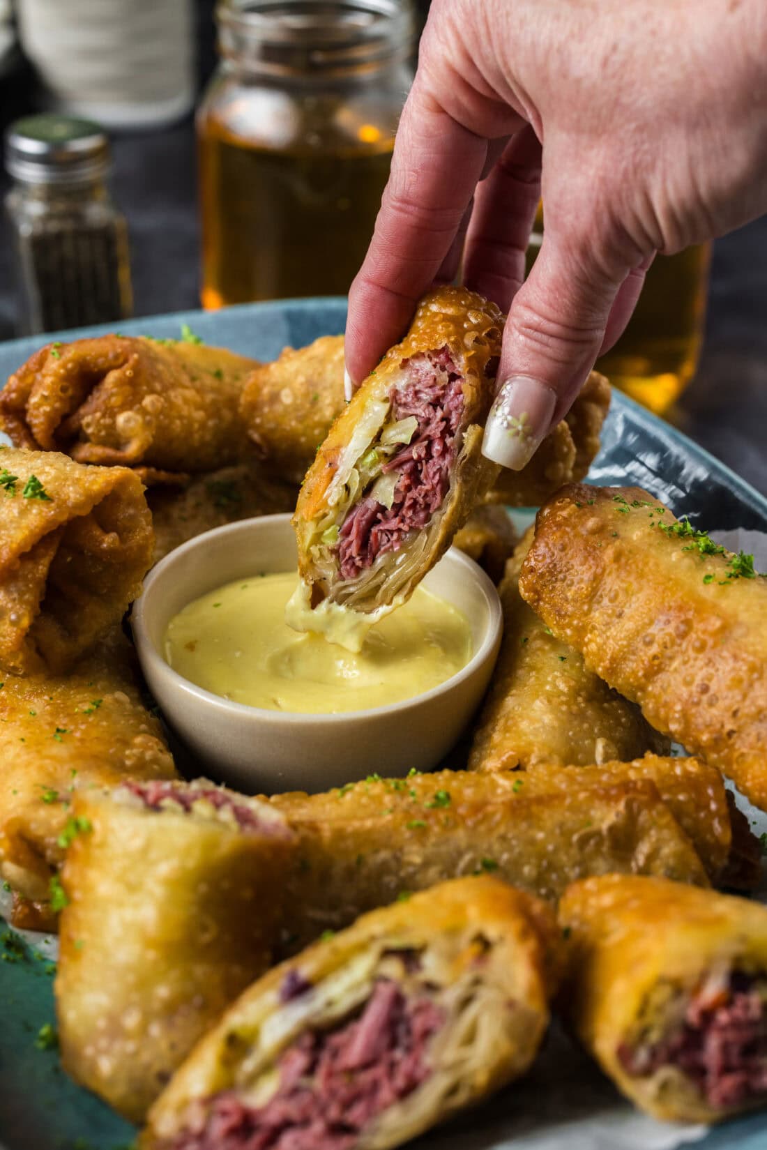 Half a Corned Beef Egg Roll dipping in dressing