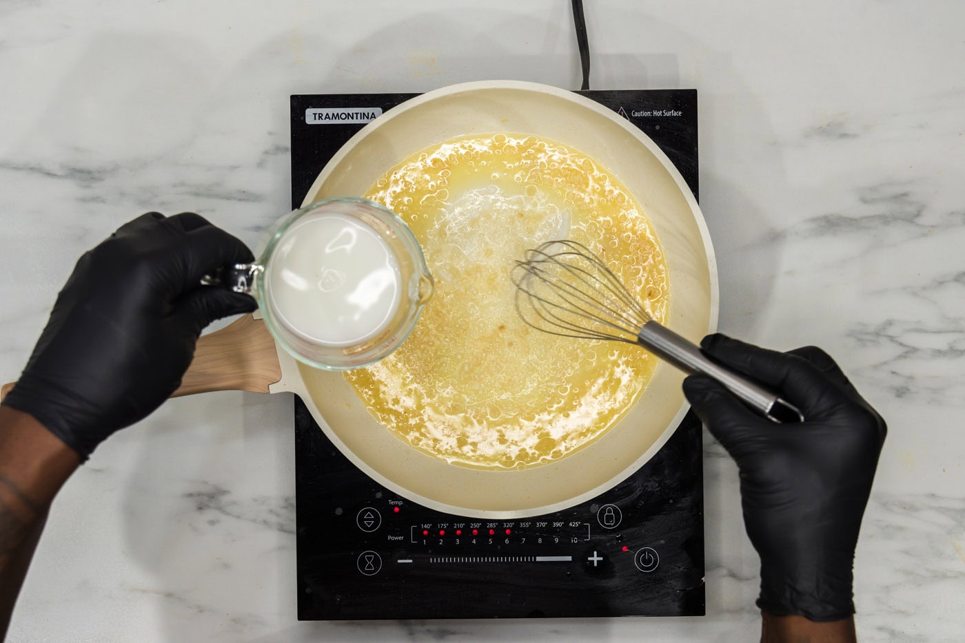 whisking cornstarch into satueed garlic and butter in a skillet