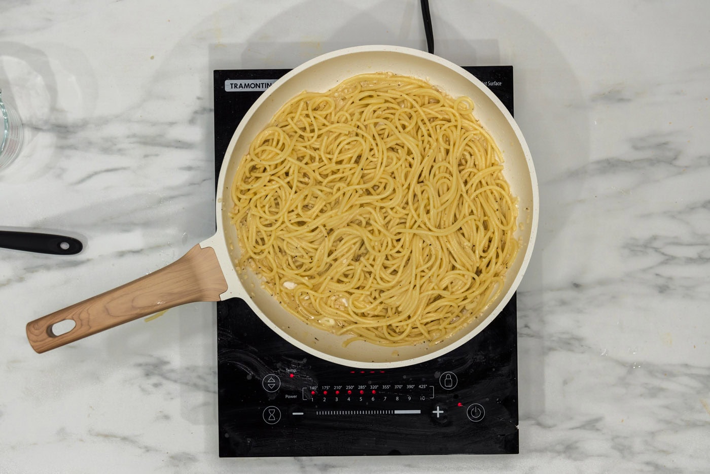 garlic butter pasta in a skillet on a burner