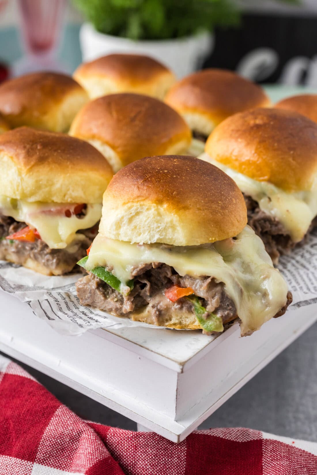 Philly Cheesesteak Sliders on a white serving board