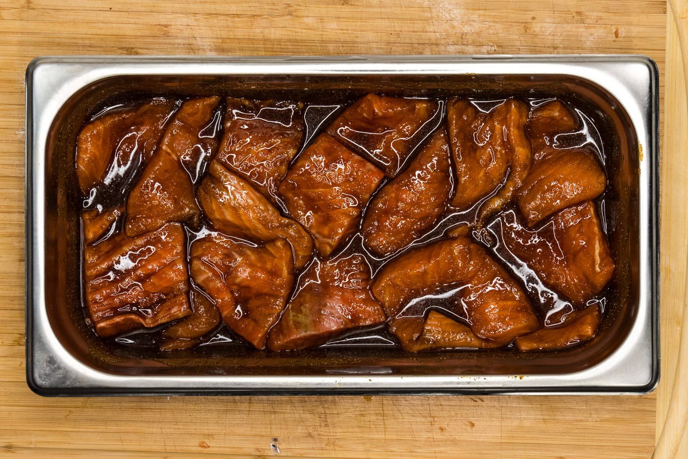 marinated salmon slices in a tray