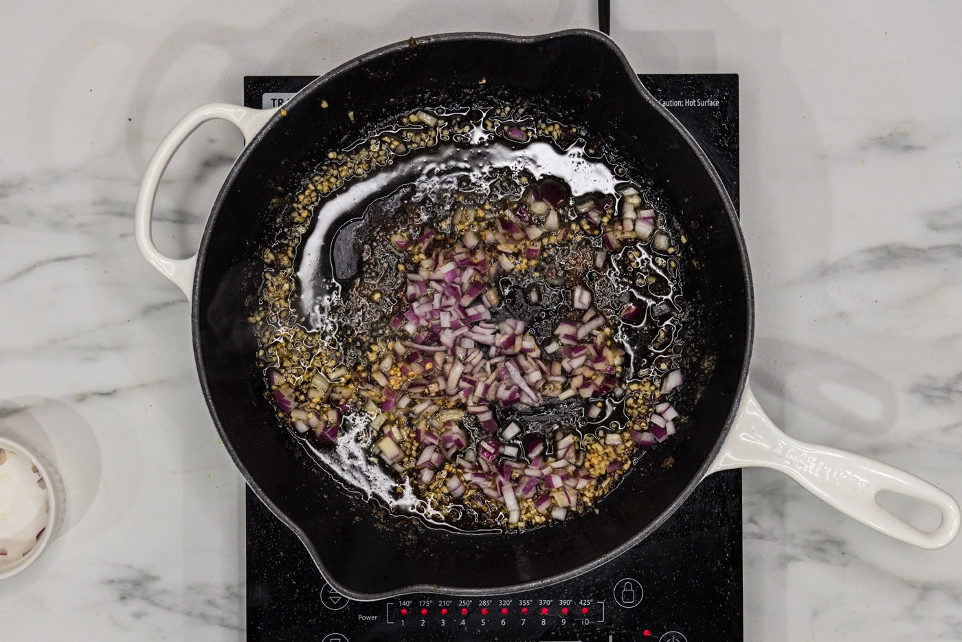 garlic and red onion in a skillet