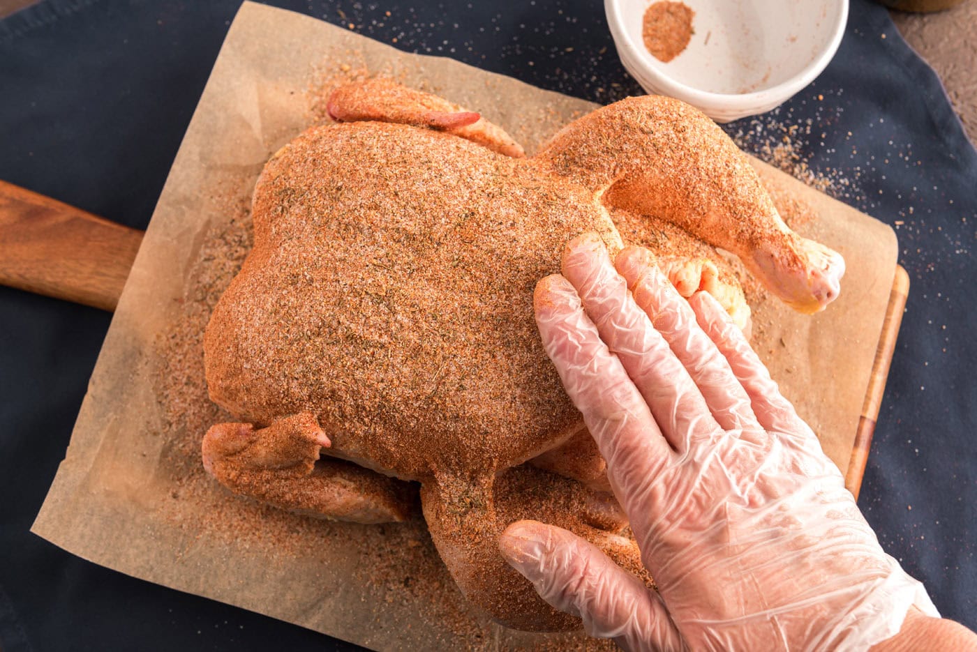 rubbing whole chicken with seasoning