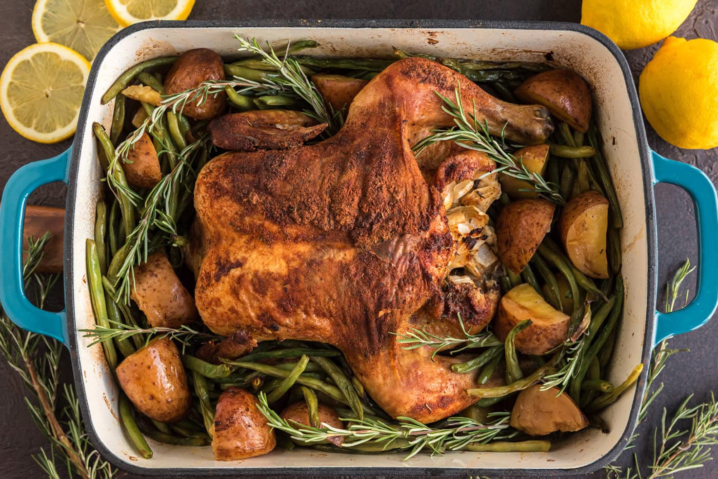 slow roasted sticky chicken overhead in a pan with green beans and potatoes