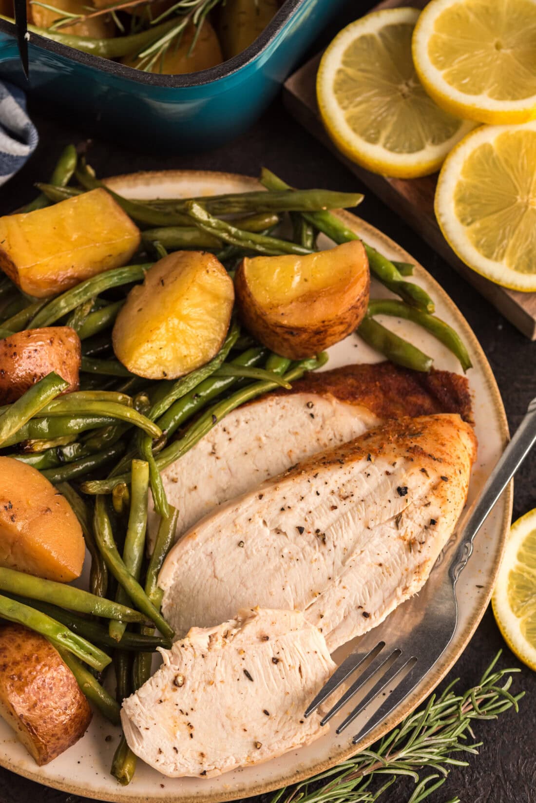 Slices of Slow Roasted Sticky Chicken on a plate with vegetables