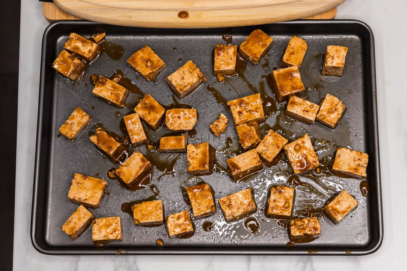 sauced tofu on a baking sheet