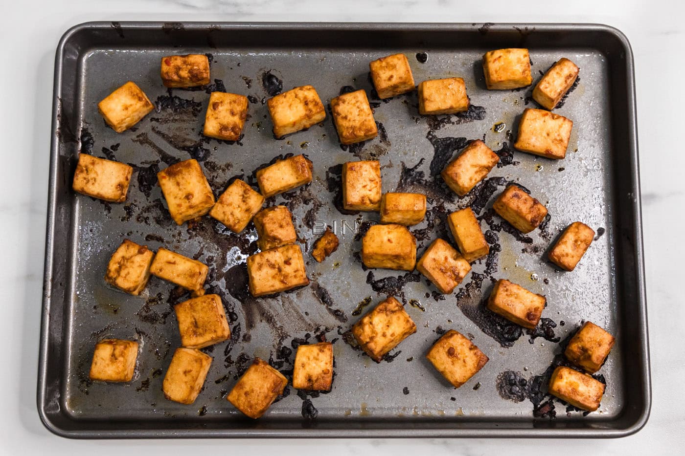 baked spicy tofu on a baking sheet