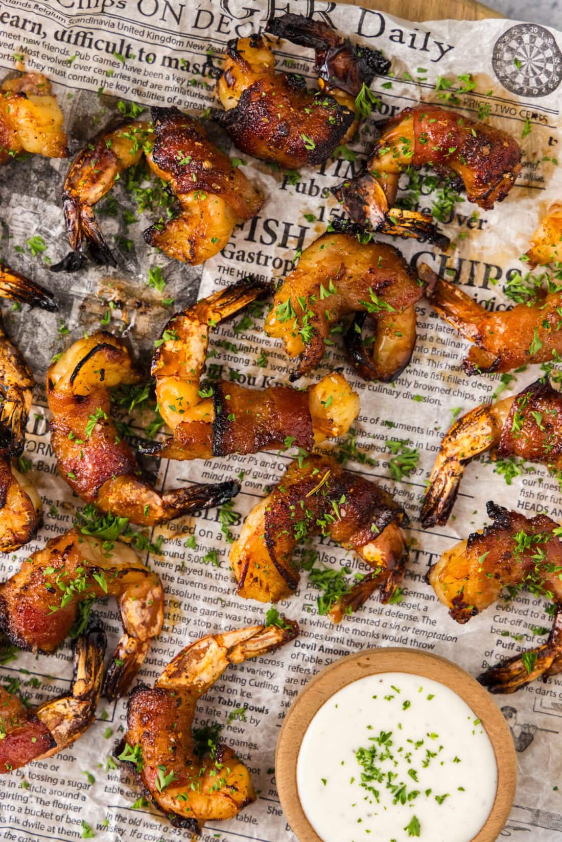 Close up photo of Air Fryer Bacon Wrapped Shrimp on parchment paper