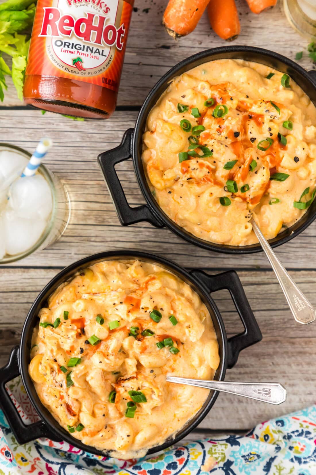 Two bowls of Buffalo Chicken Mac and Cheese topped with green onions