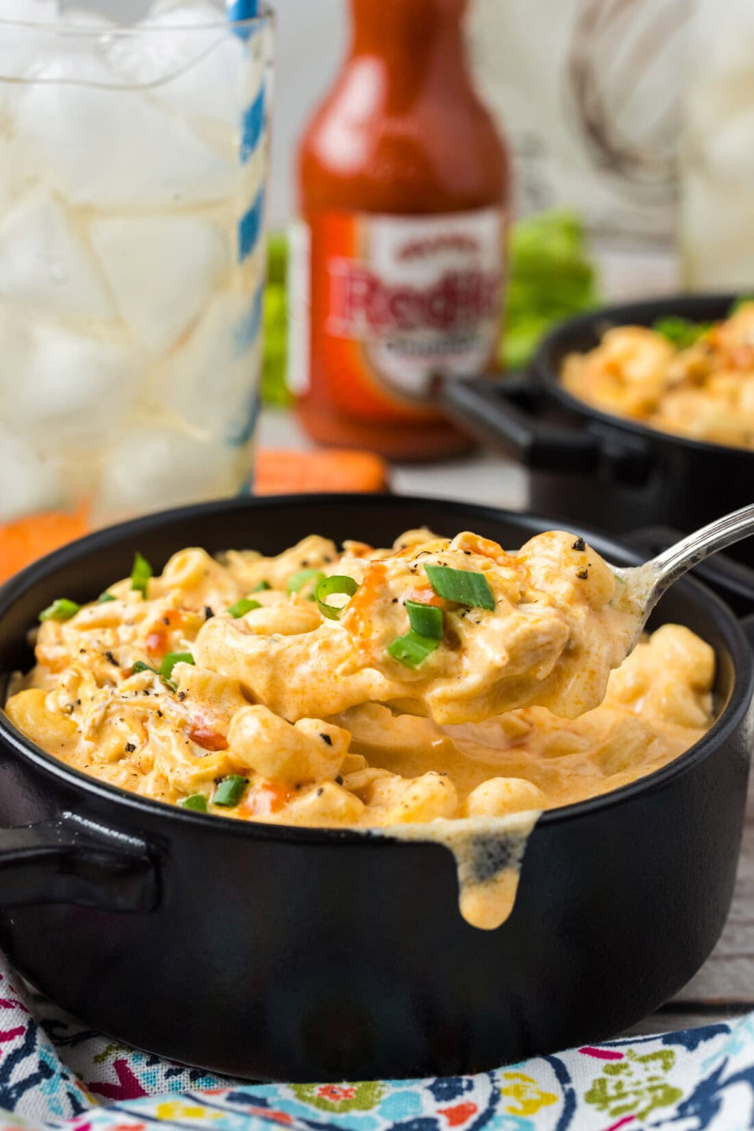 Spoonful of Buffalo Chicken Mac and Cheese being lifted out of a bowl