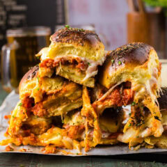 Close up photo of a stack of Chicken Parmesan Sliders