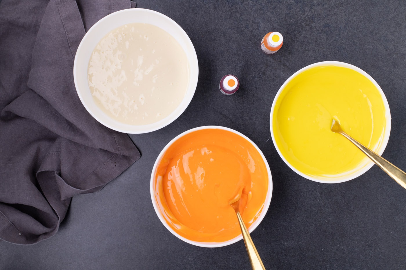 yellow, orange, and cream colored bowls of cheesecake filling