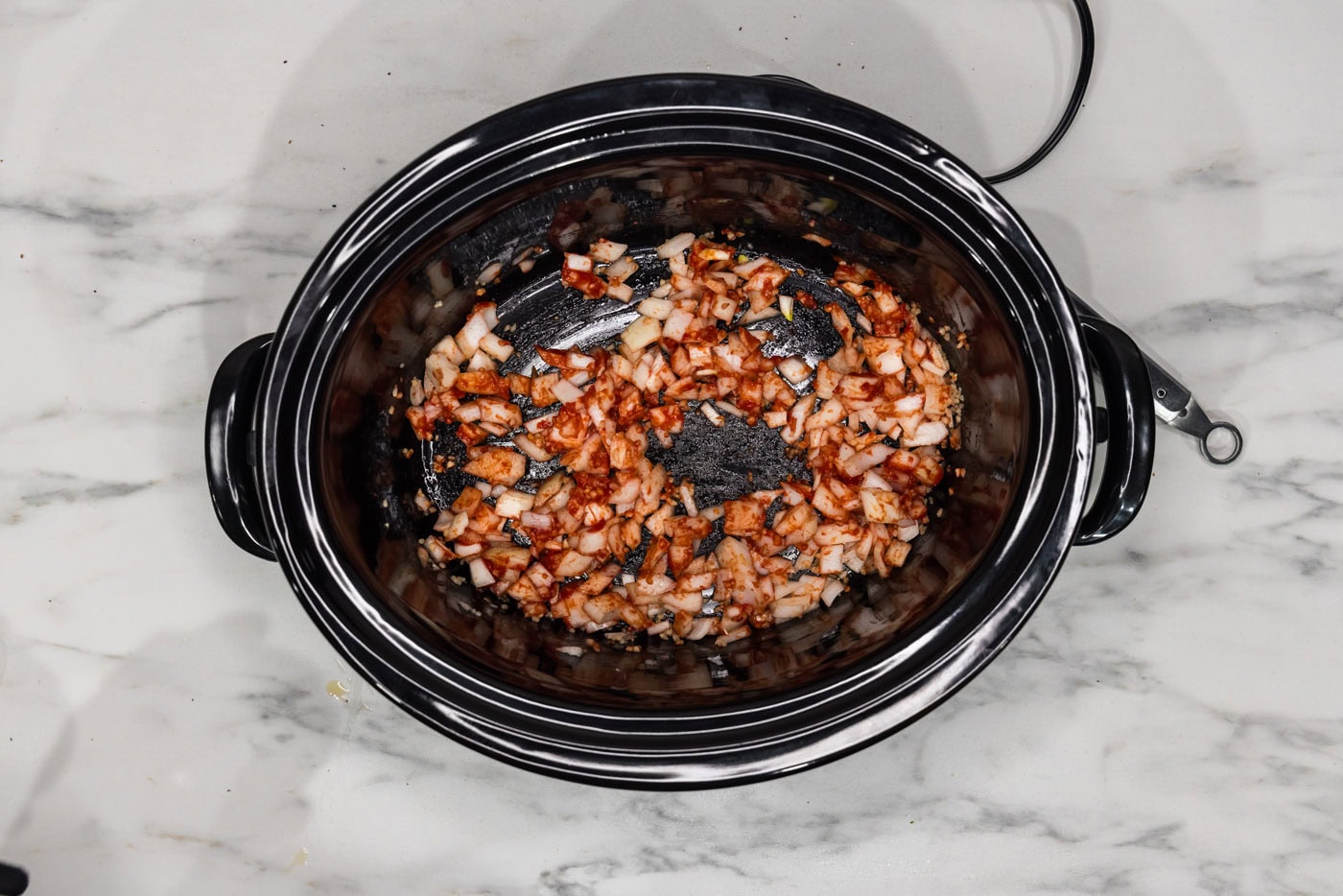 tomato paste, onion, and garlic in a crockpot