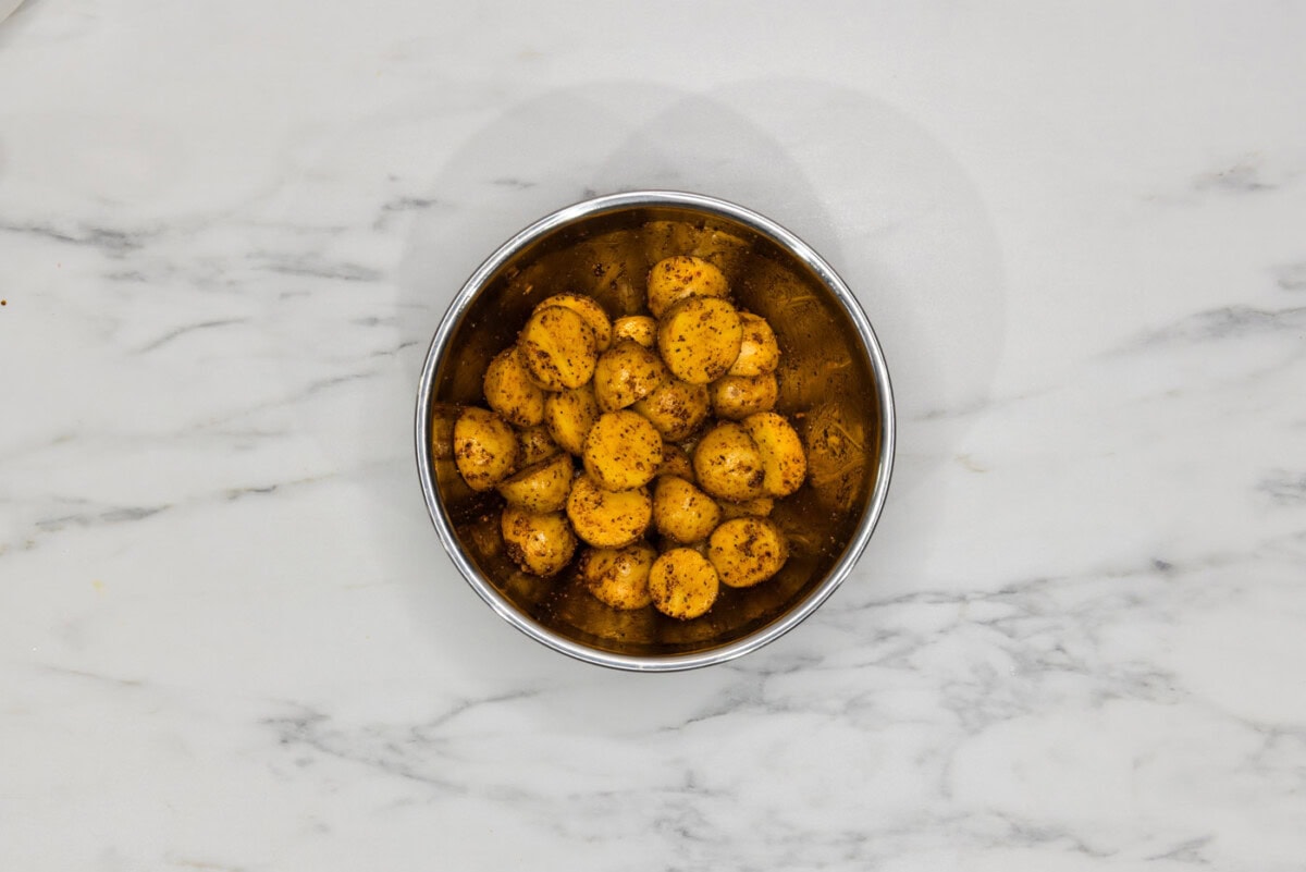 seasoned baby potatoes in a mixing bowl