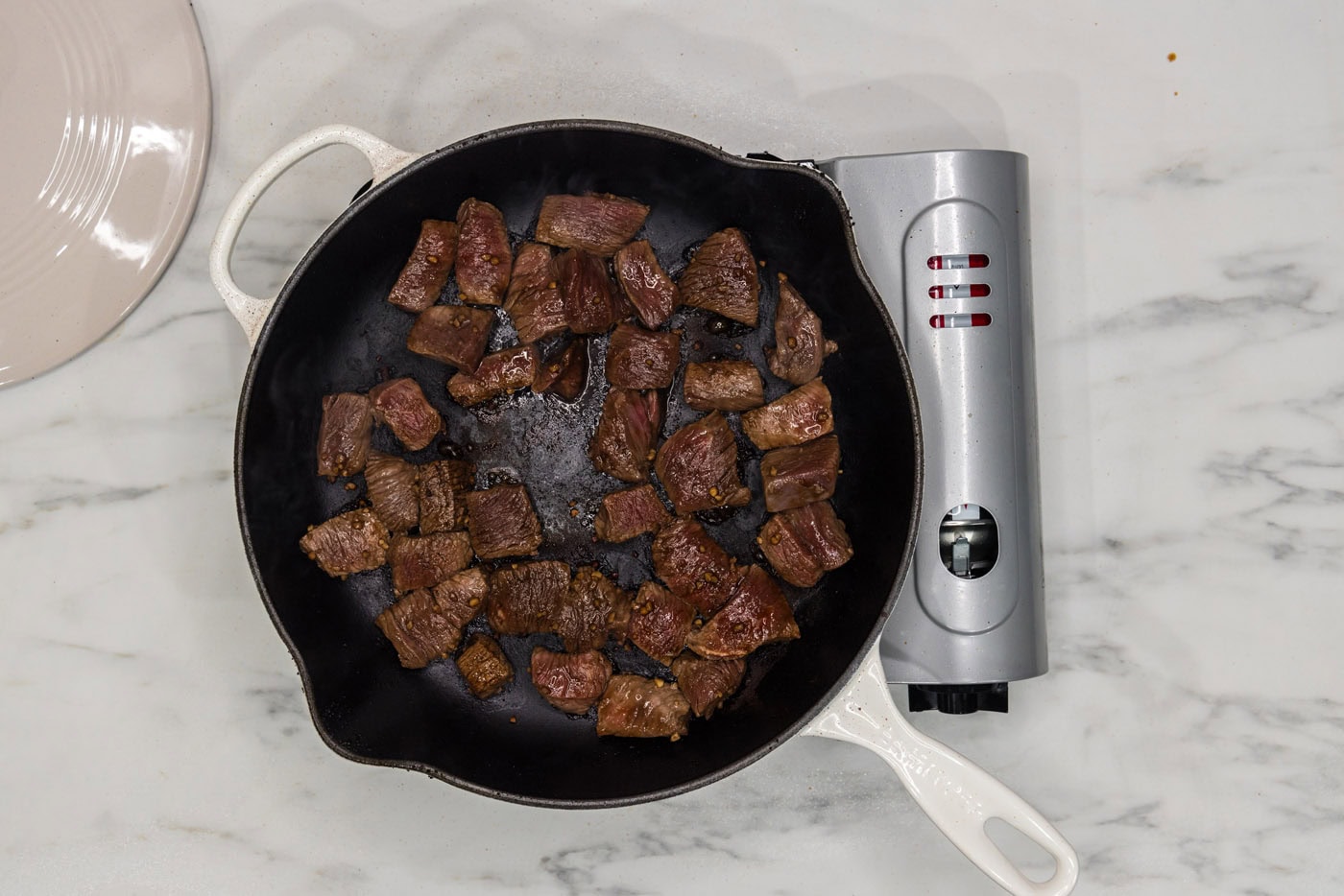 cubed steak cooking in a skillet