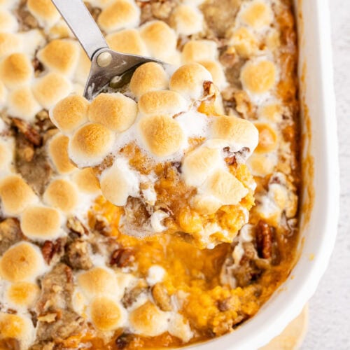 Close up photo of a spoonful of Sweet Potato Casserole in the casserole dish