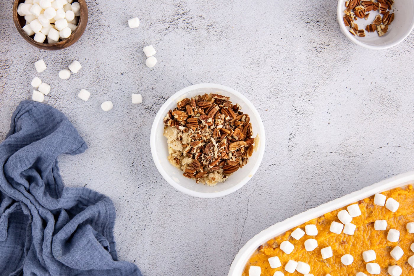 pecans added to streusel topping in a bowl