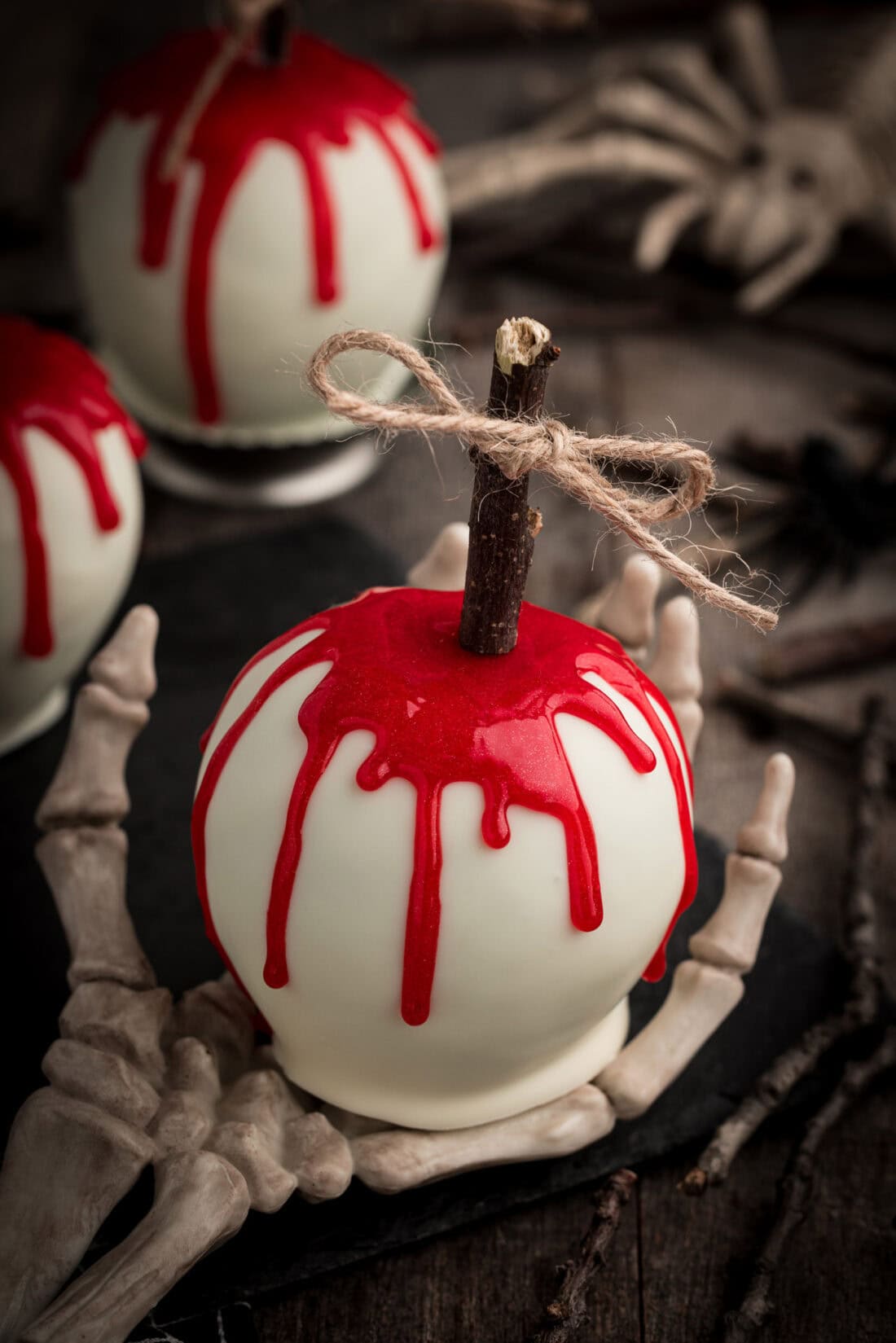 Bloody Candy Apple resting on a skeleton hand