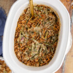 Overhead photo of Green Bean Casserole in a Crockpot with a spoon in it