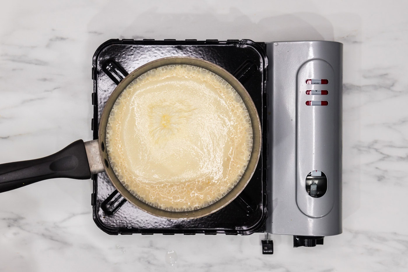 cheese sauce in a saucepan for scalloped potatoes