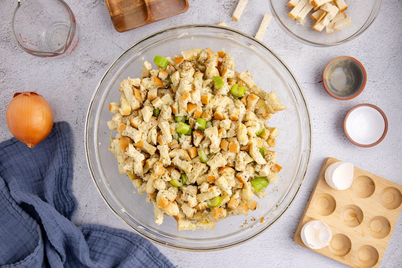 dried bread cubes with celery and onions in a large mixing bowl