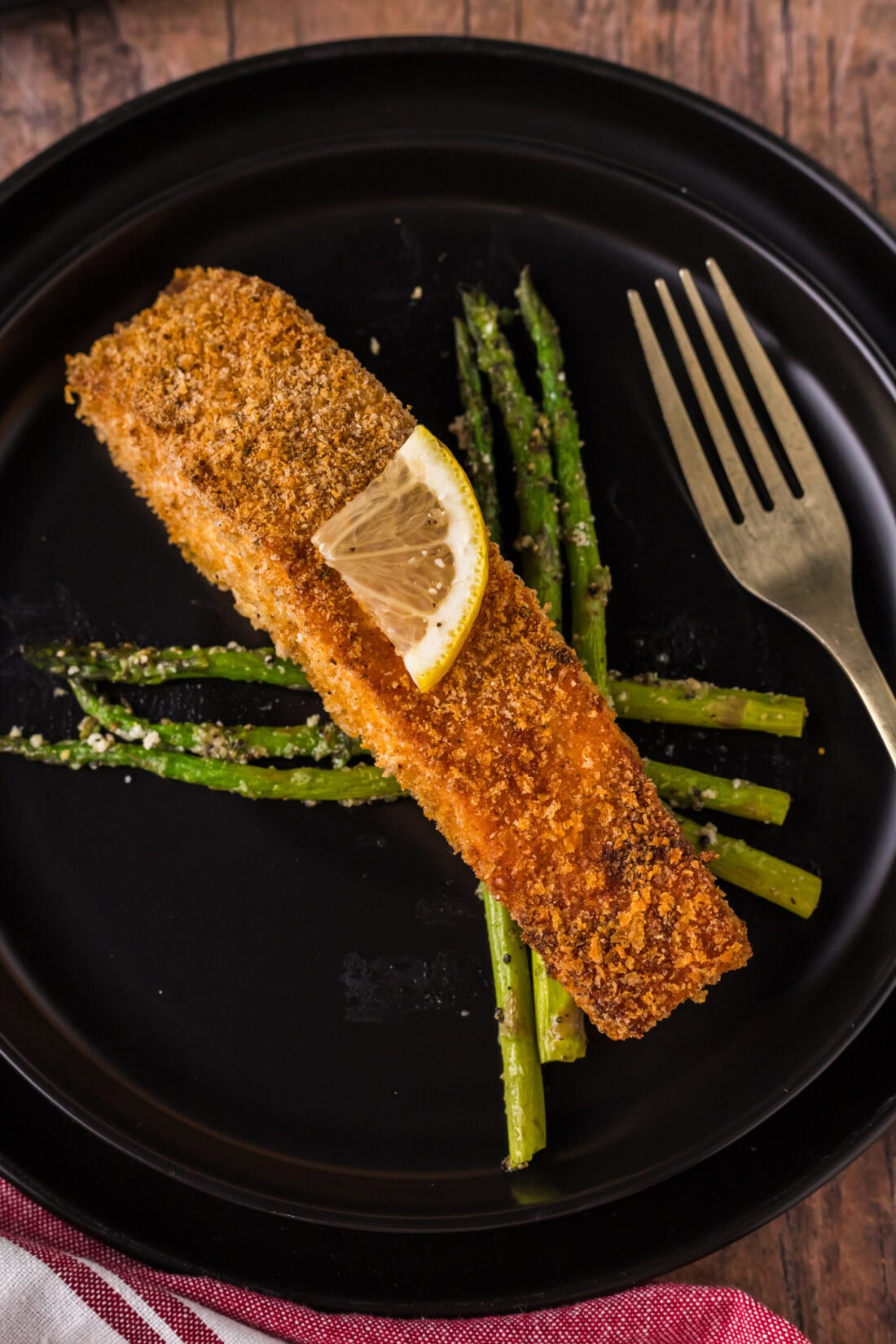 Crusted Salmon plated over asparagus 