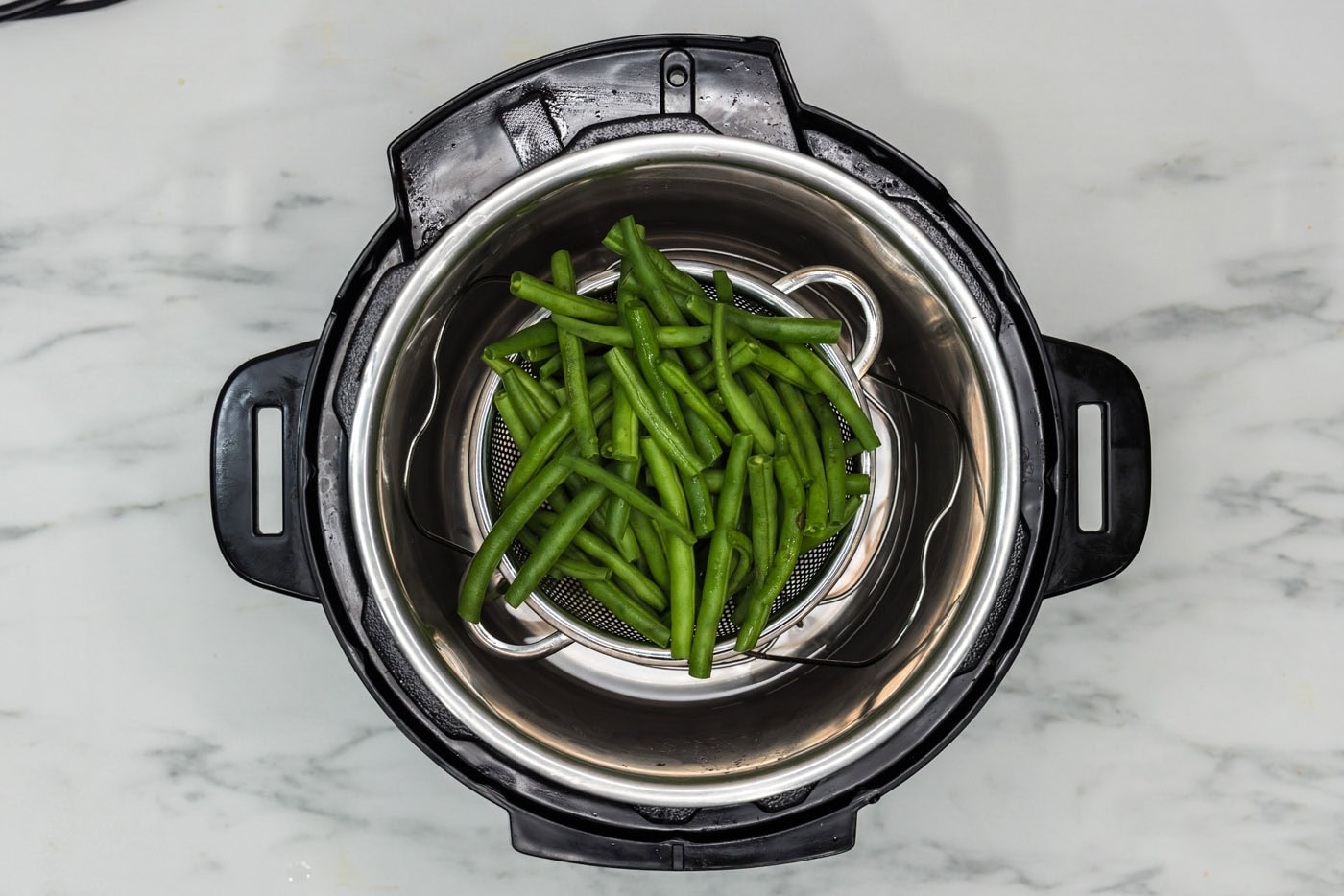 green beans in basket inside the instant pot