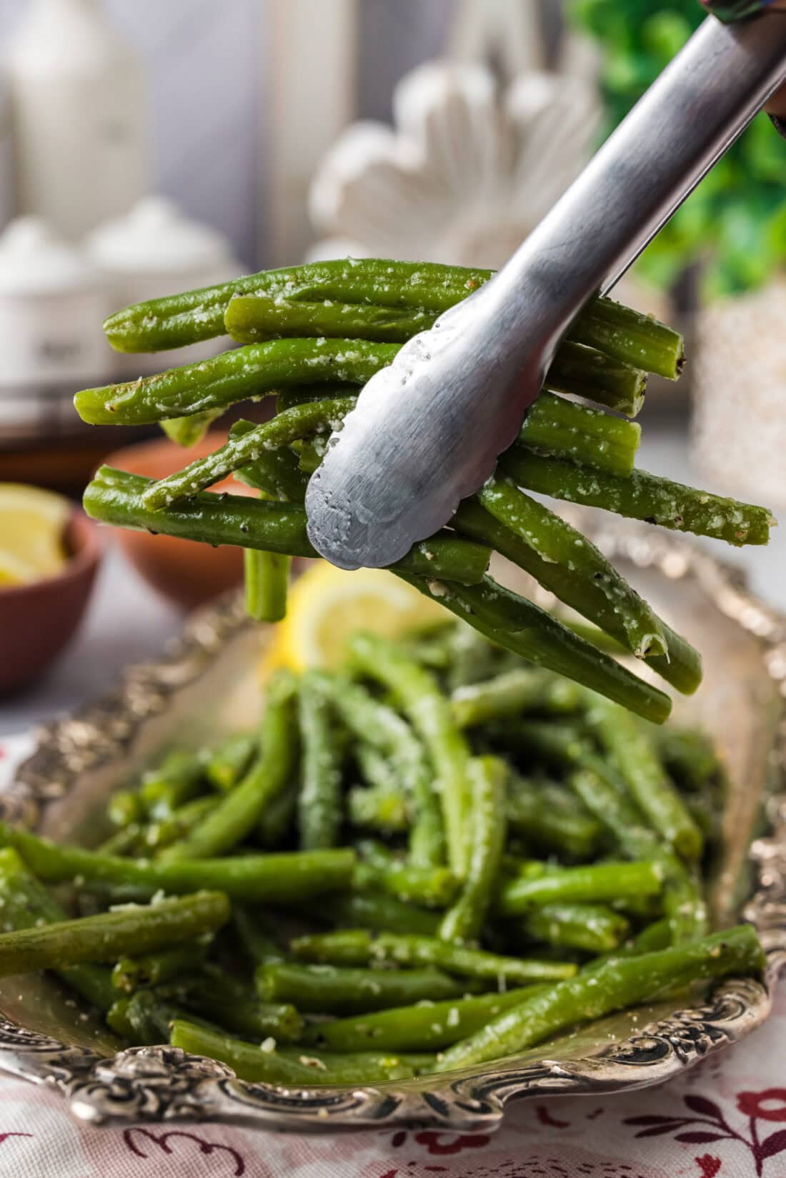 Tongs holding up a bunch of Instant Pot Green Beans