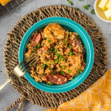 Close up photo of a bowl of Instant Pot Jambalaya with a fork resting on the side