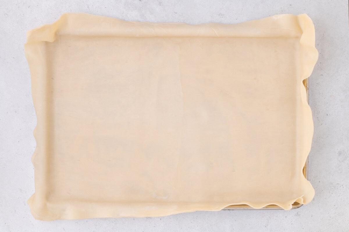 pie crust draping over a jelly roll pan