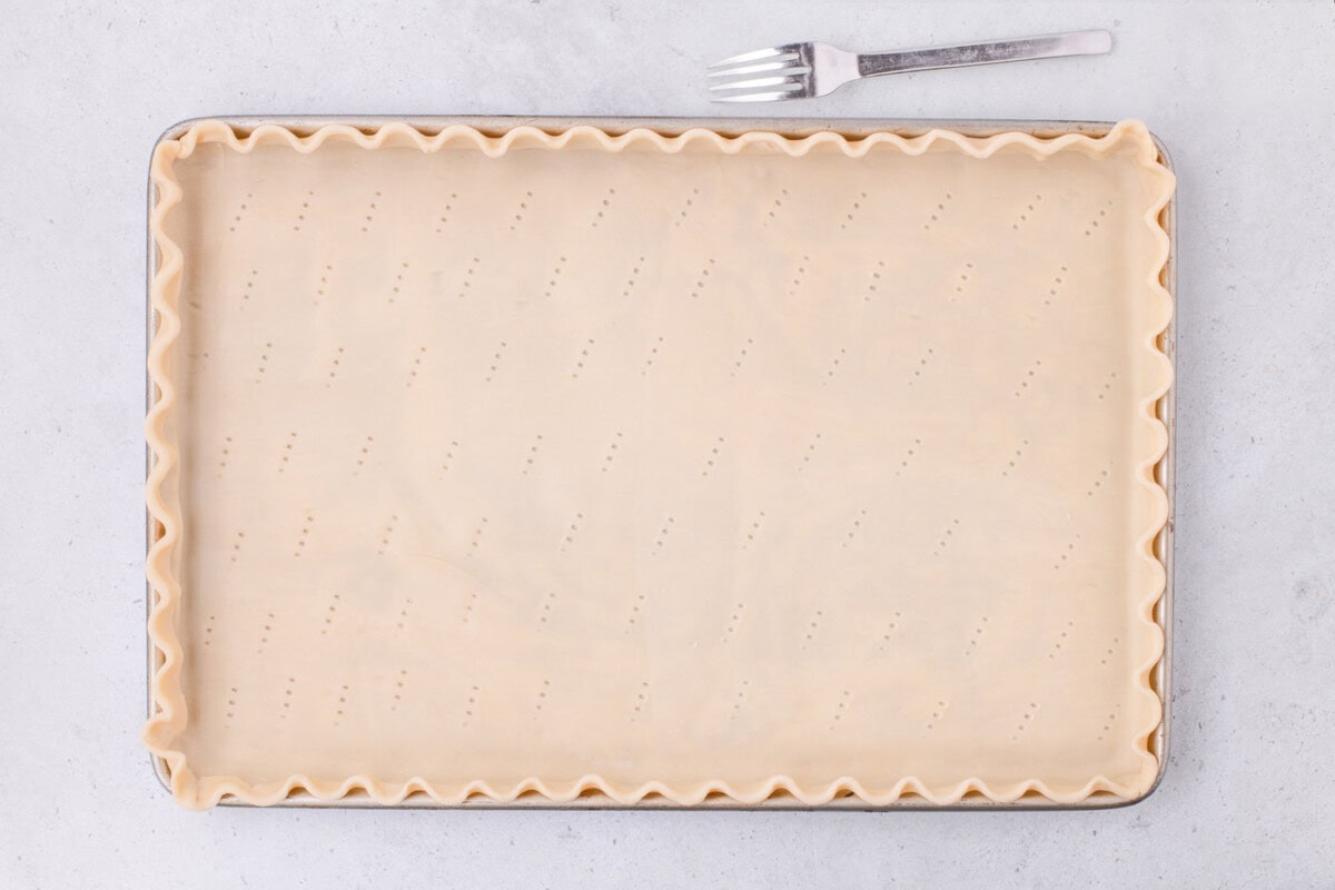 scalloped pie dough in a jelly roll pan